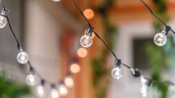 A string of clear glass bulbs with visible filaments, hanging in a dimly lit indoor setting.