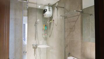 Un baño moderno con ducha de vidrio, inodoro y lavamanos.
