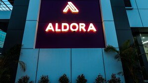 A building with a prominent 'ALDORA' sign in bright lights. - Aldora Airport Residency (Aluva)