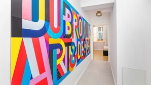 A hallway with a colorful, large-scale graphic on the wall. - Cap rooms (Dubrovnik)