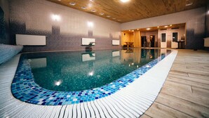 An indoor swimming pool with a wooden floor and tiled walls. - Qız Qalası Hotel (Baku)