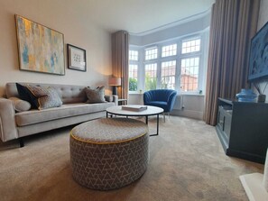 Relax in this stylish living room with a comfortable sofa, armchair, and coffee table.