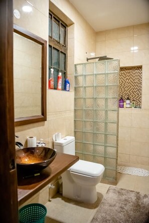 Shower, rainfall showerhead, slippers, towels