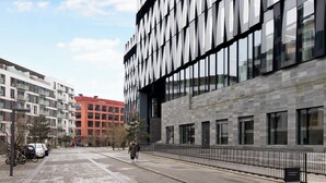 A modern building with large windows and a paved walkway. - Charm 2 - Great 2-bdr Apt With Shared Garden and Balcony (Copenhagen)
