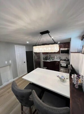 Kitchen area with central island, oven, and microwave, plus a convenient bar seating area.