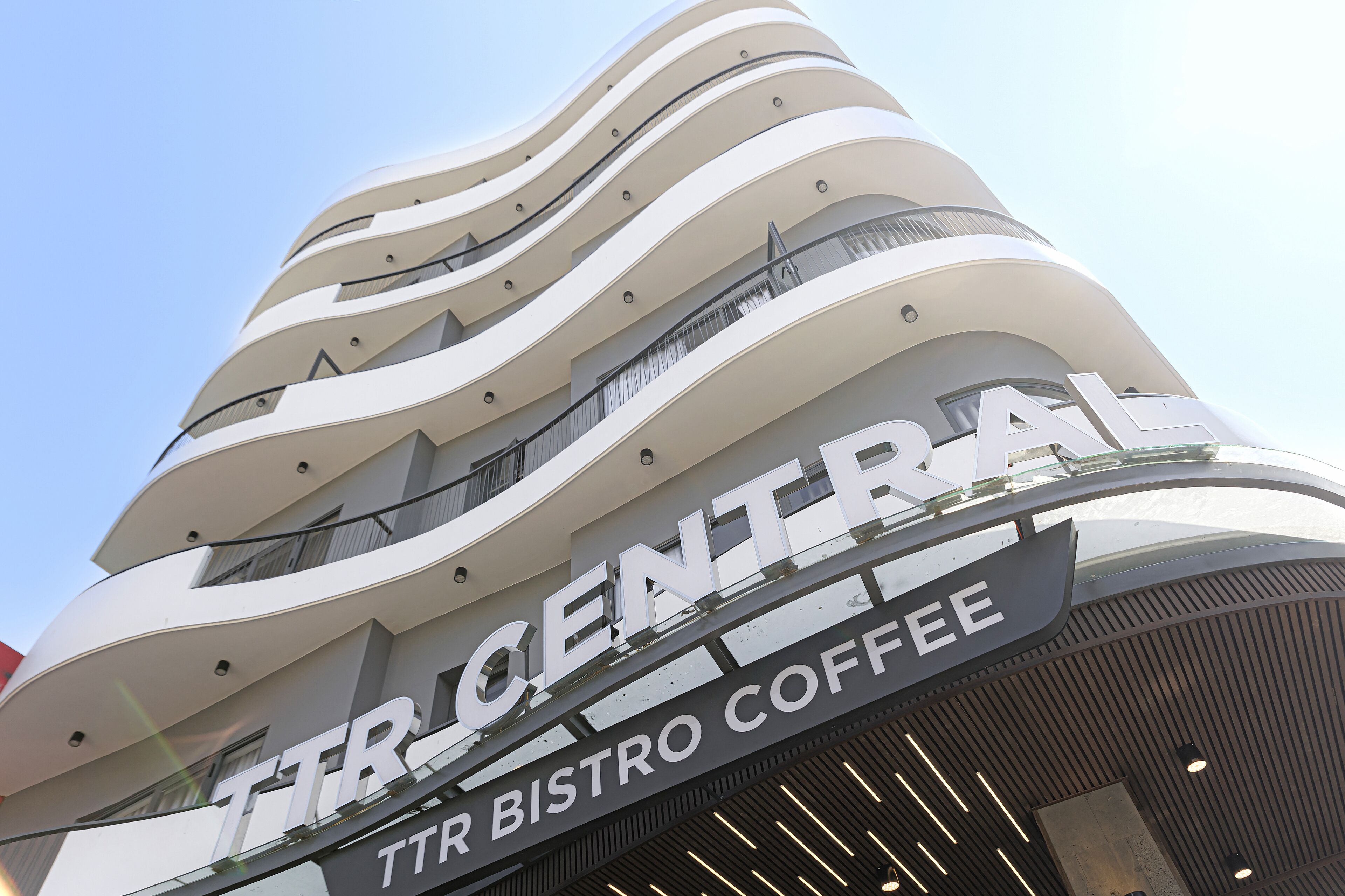 A multi-story building with a sign reading "TTR BISTRO COFFEE".