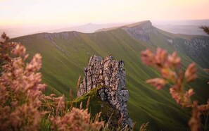 A rocky outcrop with a mountainous landscape in the background.