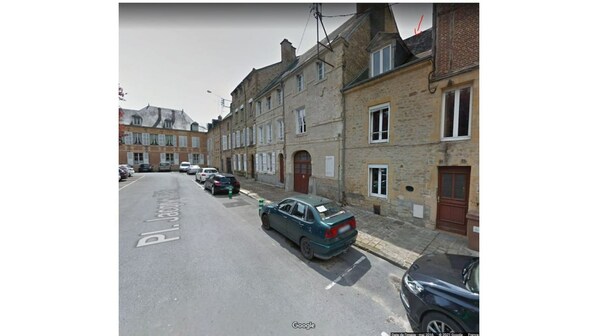 A street view with parked cars and buildings.