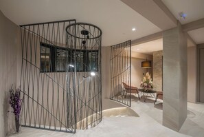 Enjoy meals and gatherings in this stylish space with a central partition, dining area, and ambient lighting.