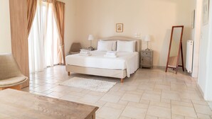 A bedroom with a bed, bedside tables, a mirror, and a chair. - Kos Secret Villa with private pool (Kos)