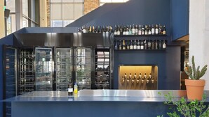 A modern bar area with a variety of wine bottles and a selection of taps. - JUNIBINO HOTEL Hongdae (Seoul)