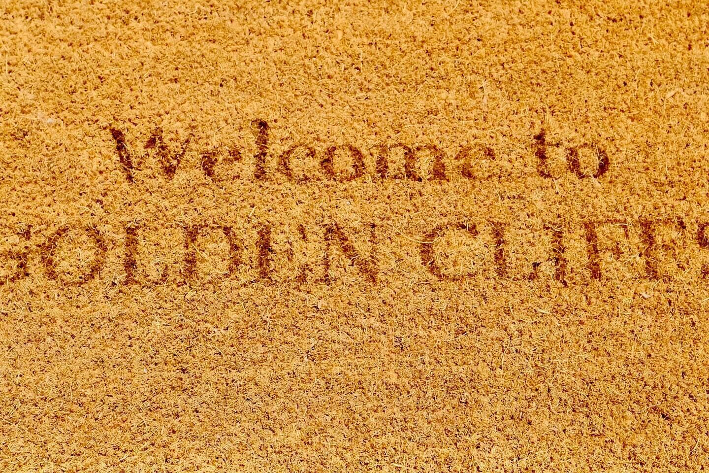 A sandy surface with the text "Welcome to GOLDEN CLIFFS" engraved.