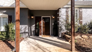 A house with a brick exterior, a wooden porch, and a mailbox marked with the number 6721. - Cozy Escape! Modern/Luxe style w/2 Master en Suites-Fireplace-Fenced- SouthPark! (Charlotte)