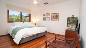 Relax in a serene bedroom with a large bed and stunning natural views.
