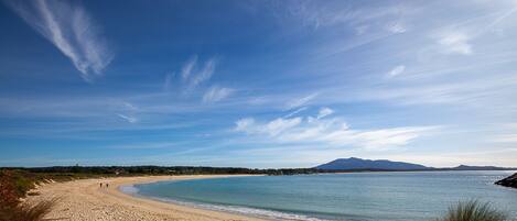 A beach with a clear sky and calm sea.