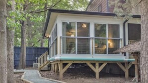 A house with a covered porch, a staircase leading to the entrance, and a fenced backyard. - Eclectic Forest View Efficiency in Quiet Chapel Hill Neighborhood (Chapel Hill)