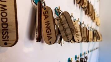 A wall with multiple wooden name tags hanging from a metal rod.