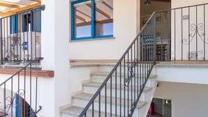 Eine Treppe mit Metallgeländer, die zu einer zweiten Etage führt.