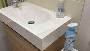 A bathroom with a white sink, a wooden vanity, and a toilet. - 🌹🍾Superb studio 5 mins from cathedral 🥂 (Reims)