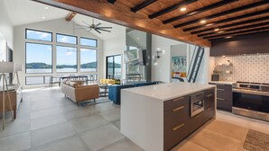 A spacious kitchen with a large island, modern appliances, and a view of the outdoors. - Lavish Lake Getaway W/180* Views+ Boat Dock (Knoxville)