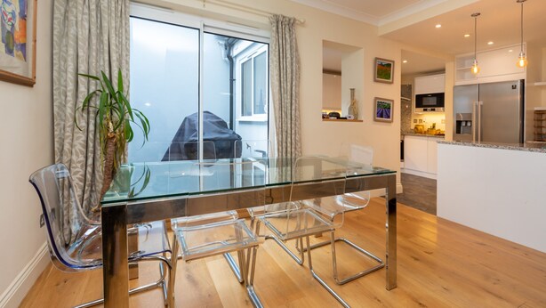 A modern kitchen with a stainless steel refrigerator, a microwave, and a built-in oven. - Modern and Bright 3 Bedroom House in Paddington (London)
