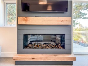 32-inch TV with cable channels, fireplace