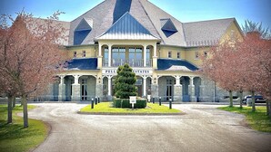 A large, two-story building with a prominent gabled roof and a central entrance.