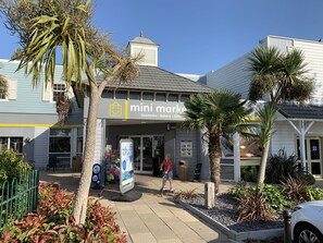 A storefront with a sign reading 'mini mark' offering groceries, bakery, and gifts. - Licence to Chill (Poole)