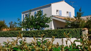 A two-story white building with blue shutters, a tiled roof, and a visible antenna. - Maison 60 Mètres mer et Plage (Saint-Denis-d'Oléron)