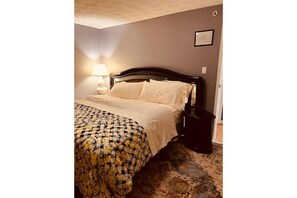 Cozy retreat with a single bed, nightstand, and patterned rug.