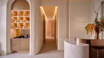 Welcome to our reception area, featuring a well-lit reception desk and a beautiful arched doorway.