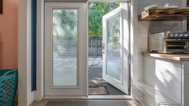 Una cocina con una puerta corredera de vidrio que da a un patio trasero.