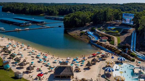 An aerial view of a beach with a water park, including a swimming pool and a covered area. - Buford Forest Retreat- Fire Pit - 5 bdrms- Sleeps 13 - Water Park, Venues, Golf! (Buford)