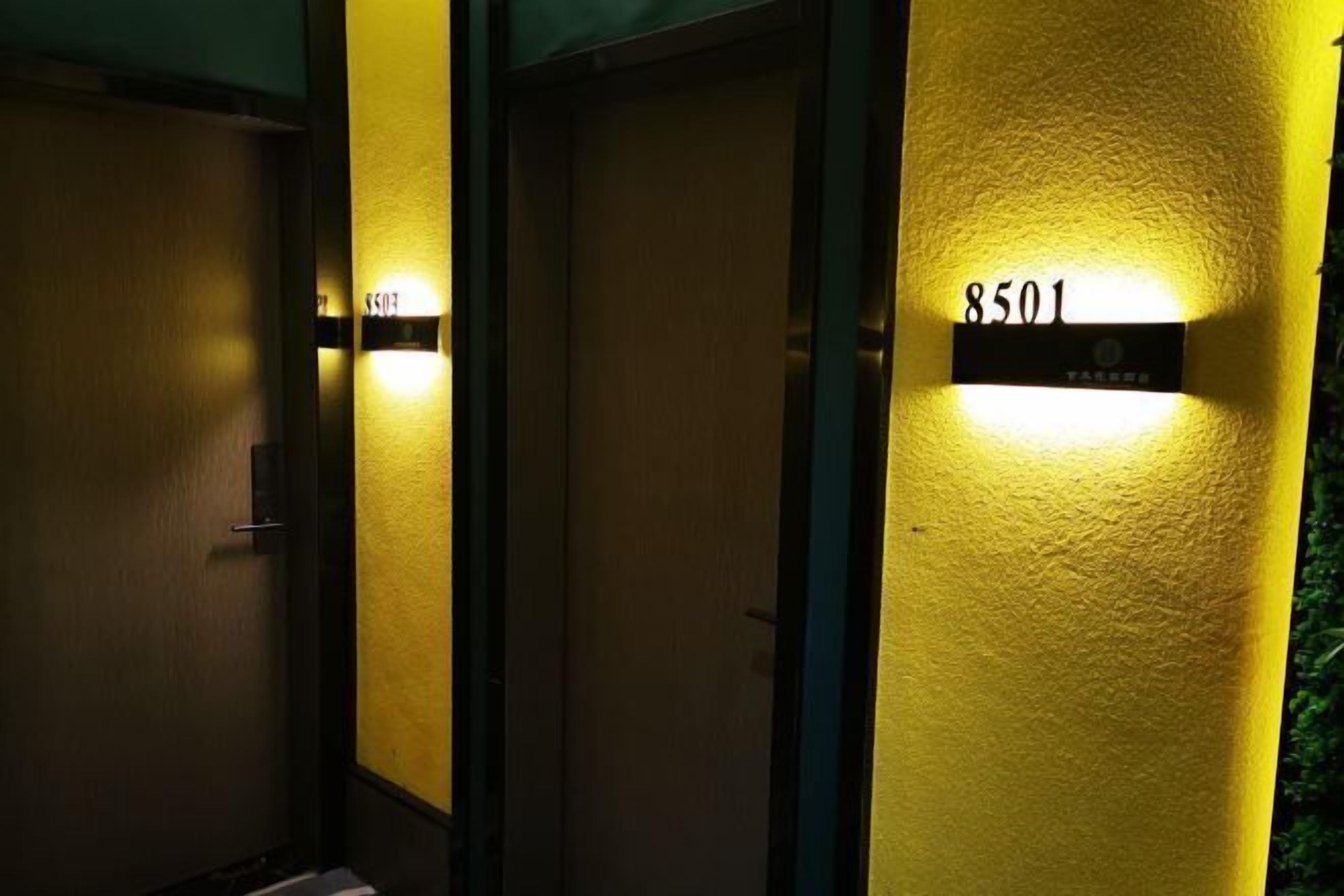 A hallway with doors, each marked with a number.