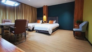 A hotel room with two beds, a desk, and a chair. - Ganmu Gardens Hotel (Susong)