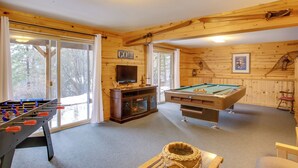 A cozy room with a foosball table, pool table, and a television. - Cave Bay Vacation Rental w/ Game Room! (Worley)