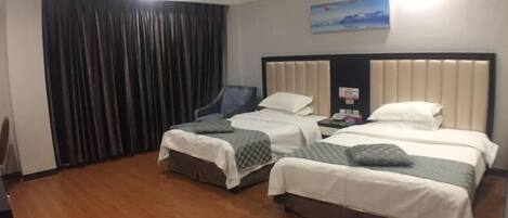 A hotel room with two beds, a chair, a desk, a painting on the wall, and a curtain.