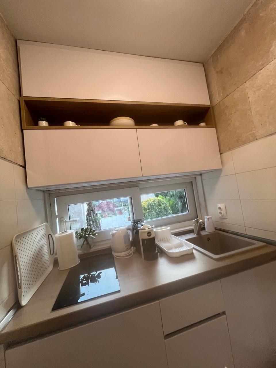 A compact kitchen with a window, a sink, and a countertop.