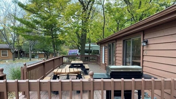 A deck with picnic tables, a barbecue grill, and a water heater. - House 70 Oasis (Put-in-Bay)
