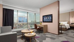 A hotel room with a city view, a desk, a bed, a sofa, and a TV. - Xiangxiang Hotel (Xiangxiang)