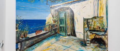 A painting of a coastal scene with a balcony overlooking the sea, featuring potted plants and a rustic door.