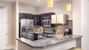 A modern kitchen with a stainless steel refrigerator, a built-in microwave, and a coffee maker. - 3BD/Vegas Oasis w/Pool, Full Kitchen, and more! (Las Vegas)