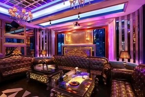 A luxurious lounge with plush seating, ambient lighting, and a decorative ceiling. - Maomingjia International Hotel (Dianbai Wanda Plaza Branch) (Maoming)