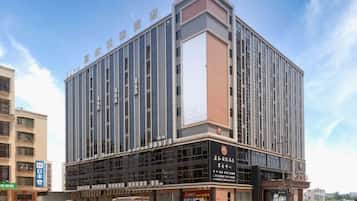 Un hotel de varios pisos con fachada moderna, amplias ventanas y una entrada destacada.