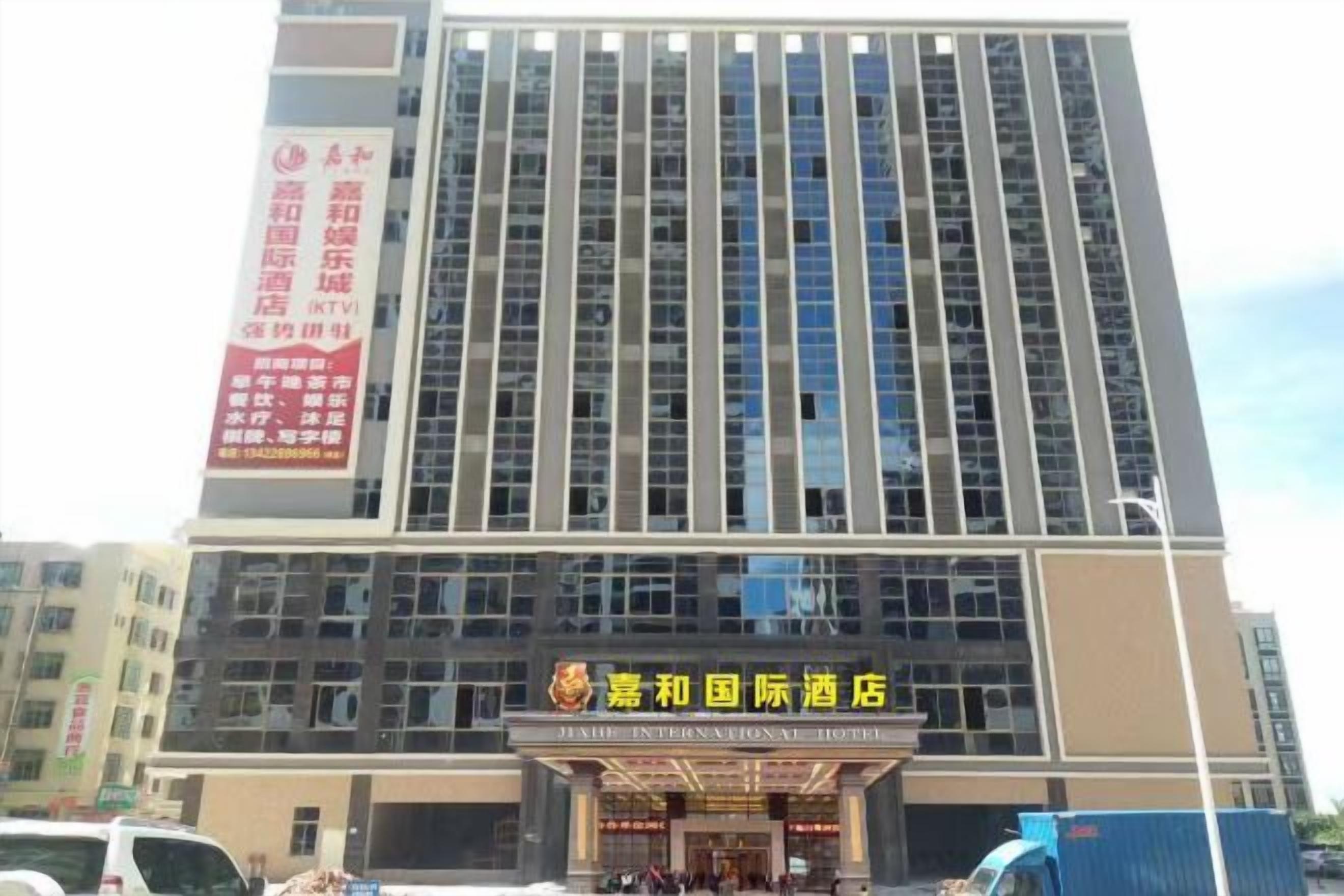 A tall hotel building with multiple floors and a prominent entrance.