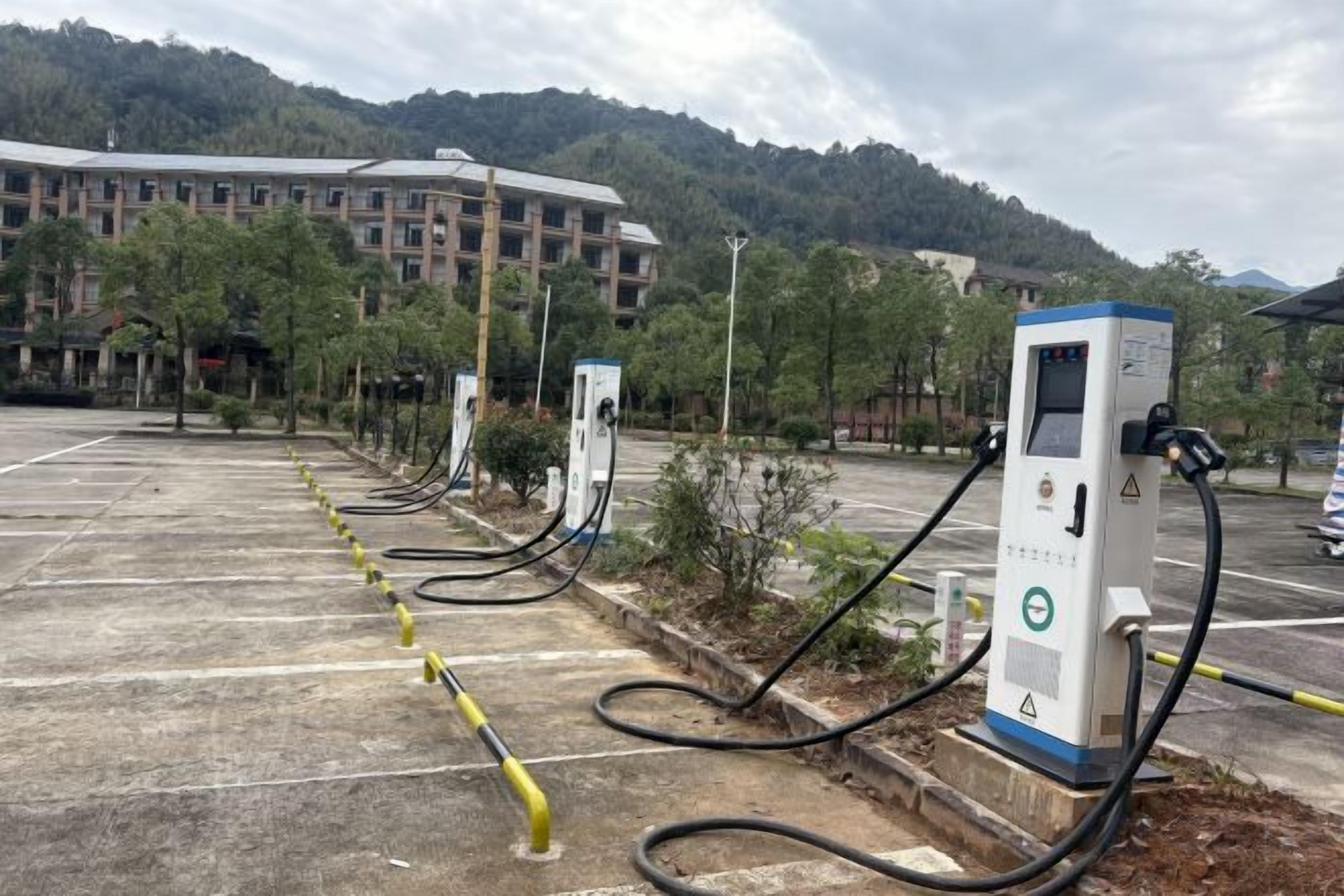 Un área de estacionamiento con estaciones de carga para vehículos eléctricos.