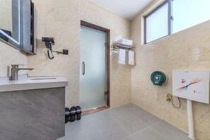 A modern bathroom with a sink, towel rack, and a shower area. - Mile Dream Tour Boutique Hotel (Mile)