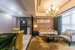 A modern hotel room with a sofa, armchairs, a coffee table, a chandelier, and a large window. - Dihao International Hotel (Guang'an)