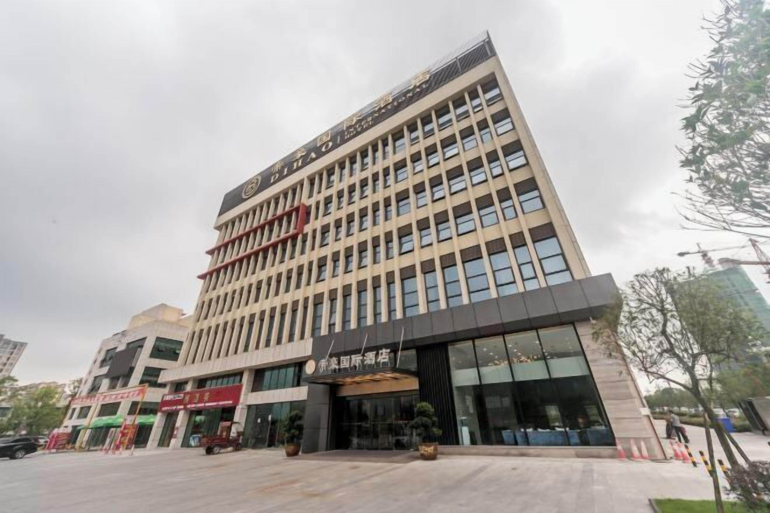 A multi-story hotel with a modern facade, large windows, and a prominent entrance with a canopy.
