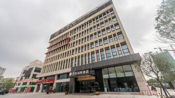 A multi-story hotel with a modern facade, large windows, and a prominent entrance with a canopy.